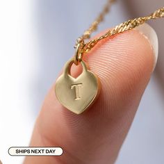 "Elevate your look with our High-Quality Heart Initial Tag Necklace - a timeless treasure for all! It's perfect for toddler girls and your mother. Materials & Finish: * 316L Stainless Steel * 14k Gold, Silver * Our products differ from regular gold plating because they are a thicker layer of 14k gold on 316L Stainless Steel, making them more durable. It offers the appearance and quality of gold jewelry at a more affordable cost. Size Specs: * Heart Initial Tag Dimensions:  10mm x 12mm * Chain Lengths: Available in multiple sizes (please select from the dropdown menu) * Necklace comes with a 2\" adjustable extender for fine-tuning. Link for just Charm: * https://www.etsy.com/listing/1325115090/add-on-gold-initial-pendant-add-letter Features: * Minimalist Personalized Design * Waterproof, Sw Heart Initial Necklace, Initial Tag Necklace, Engraved Heart Necklace, Gold Initial Pendant, Simple Gift Wrapping, Letter Pendant Necklace, Gold Initial, Tiny Heart, Simple Gifts