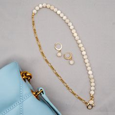 Our fine Mother of Pearl Necklace with gold-filled chain is a graceful and elegant piece that seamlessly blends sophistication with a touch of sparkle. This necklace features lustrous half mother of pearl complemented by a half fine gold-filled chain. The front hook, adorned with a glistening rhinestone, not only adds a hint of glamour but also serves as a stylish closure. The delicate design ensures that this necklace can effortlessly elevate both casual and formal ensembles. The combination of Gold Mother Of Pearl Necklace With Pearl Chain, Gold Mother Of Pearl Jewelry With Pearl Charm, Elegant Gold Pearl Necklace With Lobster Clasp, Everyday Elegance Gold Jewelry With Pearl Chain, Dainty Gold Mother Of Pearl Necklace, Gold-plated Pearl Necklace With Gold Chain For Gift, Gold Jewelry With Pearl Charm For Everyday Elegance, White Pearl Jewelry With Gold Chain, Minimalist Gold Jewelry With Mother Of Pearl