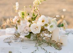 a table set with flowers and silverware