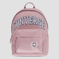 Carry your stuff in All Star style with this backpack from Converse. It's made of durable poly fabric and features a varsity style applique patch as well as the Chuck Patch logo. The main compartment has a 2-way zip closure and is spacious enough to hold text books, a change of clothes, your lunch or any other items you want to take along for the day. One the back there is a zippered padded compartment that can be used to store your laptop or tablet and the front zip pocket can be used to secure Casual School Backpack With Logo Patch, Back To School Standard Backpack With Logo Patch, Casual Backpack With Embroidered Logo, School Backpack With Logo Patch, Standard School Backpack With Logo Patch, Casual Standard Backpack With Embroidered Logo, Pink College Bag For Back To School, Casual Nylon Backpack With Logo, Sporty Pink Backpack For Streetwear