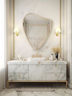 a bathroom with marble counter tops and gold accents