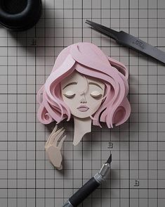 a paper cut out of a woman with pink hair