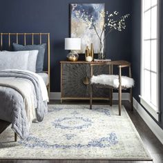 a bedroom with dark blue walls and white bedding, gold furniture and rugs