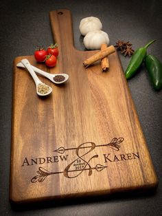 a wooden cutting board with spices and vegetables on it