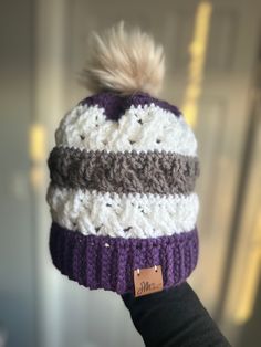 This super comfy beanie is exactly what you need this winter! The hats are crocheted and made with 100% acrylic yarn.  The purple, white, and gray hat fits a large child/small adult head. It is 7.5" tall when laid out, 10" with the pom pom included. It is also stretchy. The pom pom is faux fur. This hat was created based on the pattern found at this link: https://www.crochetforyoublog.com/2023/09/crochet-celtic-stripes-beanie/. Please contact me with any questions! White Acrylic Beanie One Size, Warm Purple Beanie Cap, White Casual Acrylic Beanie, White Acrylic Casual Beanie, Purple Beanie Cap, Purple Knitted Beanie Hat, White Acrylic Yarn Beanie For Winter, Warm Purple Crochet Hat For Winter, White Warm Beanie One Size Fits Most