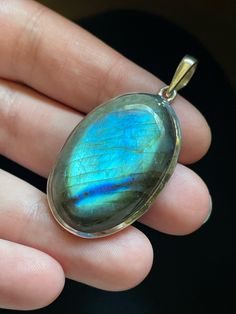 This oval Labradorite pendant is handmade and set in solid Sterling Silver. Each unique Labradorite stone has opalescent colors and shimmering patterns that are pure magic! Labradorite is in the Moonstone and Spectrolite mineral family and gets its name from the place it was originally discovered: Labrador, Canada. It is often referred to as a "Dream Stone" as it enhances the power of dreams and manifestation. Labradorite has the power to help you make your dreams come true! Shoot for the stars! Oval Labradorite Cabochon Jewelry, Oval Cabochon Labradorite Jewelry, Oval Moonstone Natural Stones, Oval Natural Moonstone Gemstones, Oval Labradorite Necklace With Large Stone, Spiritual Labradorite Jewelry With Natural Inclusions, Unique Iridescent Oval Jewelry, Unique Oval Iridescent Jewelry, Labradorite Pendant With Natural Stones