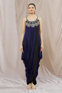 Blue cowl draped dress, elevated with mirror embellished yoke on a multi-colored thread embroidered base. Comes with long jade jacket, elevated with all over floral print and mirror embellished border.
Component: 2
Pattern: Print,Embellished,Embroidery
Type Of Work: Floral,Thread,Mirror
Neckline: Scoop Neck
Sleeve Type: Sleeveless
Fabric: Satin
Color: Green,Blue
Other Details: 
Black border draped dress
Floor length jacket
Occasion: Sangeet - Aza Fashions Hand Embellished Draped Dress For Reception, Hand Embellished Draped Dress For Festive Occasions, Festive Draped Hand Embellished Dresses, Evening Draped Dress With Mirror Work, Traditional Silk Dress With Mirror Work, Party Wear Draped Dress With Mirror Work, Draped Mirror Work Dress For Reception, Hand Embellished Dresses With Traditional Drape, Embellished Traditional Drape Dresses For Party