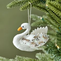 a white ornament hanging from a christmas tree