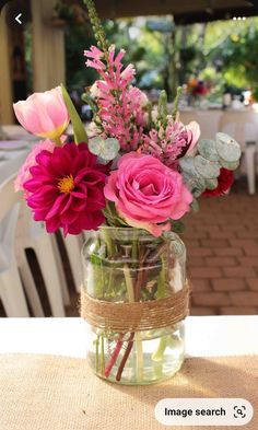 a vase filled with flowers sitting on top of a table