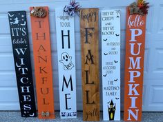 four wooden signs with words that say happy halloween and pumpkins, one for each family