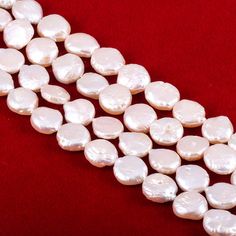 two rows of white pearls on a red background