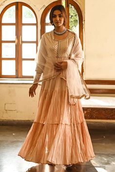 Peach cotton anarkali with an embroidered bodice. Paired with net dupatta.
Component: 2
Pattern: Embroidered
Type Of Work: Gota patti
Neckline: Round
Sleeve Type: Three quarter
Fabric: Cotton, Net
Color: Peach
Other Details: 
Fringe dupatta
Tiered anarkali
Occasion: Wedding, Reception - Aza Fashions Peach Chanderi Sets With Sheer Dupatta, Peach Anarkali Set With Sheer Dupatta, Peach Semi-stitched Floor-length Sharara, Floor-length Peach Sharara, Festive Peach Dress With Dupatta, Anarkali Choli With Resham Embroidery In Peach, Unstitched Anarkali Lehenga In Peach, Peach Anarkali Set With Resham Embroidery For Reception, Designer Peach Anarkali Set With Sheer Dupatta