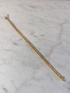 "14kt Yellow Gold Lady's Diamond Bracelet 7\" in length consisting of 3.30ct total weight full cut round brilliant white diamonds all channel set in solid heavy flexible mounting with a hidden box clasp and a fig 8 secure safety clasp closure. This Classic Style Bracelet is very flexible and comfortable to wear daily. This item would Retail for $7,350.00" Box Clasp, Channel Set, Wedding Bracelet, White Diamonds, Round Brilliant, Diamond White, Fashion Bracelets, Fig, Diamond Bracelet