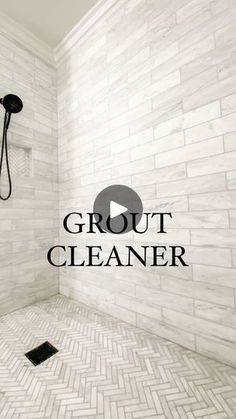 a walk in shower sitting next to a white tiled wall with the words grout cleaner on it