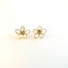 Small metal flower wire stud earrings. Unique earrings for a unique person. Not intended for children ages 13 and under. Also, for many items we can accommodate large orders, so please send us a message. Gold Wire Wrapped Flower Earrings Gift, Metal Flower Charm Earrings, Adjustable Gold Flower Earrings, Adjustable Handmade Flower Earrings, Nickel-free Flower Shaped Metal Earrings, Nickel-free Metal Flower Earrings, Delicate Gold Flower Earrings With Handmade Details, Delicate Gold Flower Earrings With Handmade Flowers, Hypoallergenic Metal Flower Earrings