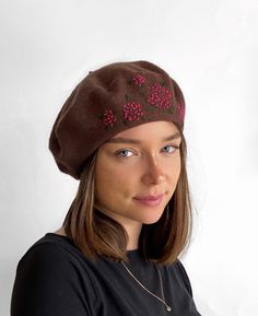 A  soft chestnut brown wool beret trimmed with delicate, coral hand embroidered hydrangea flowers for a feminine, unique look. The beret is an all-time classic that is the perfect flattering accessory for the cooler seasons. Easy to wear and reliable, you don't even need a mirror to style it on your head! Keep it folded flat in your bag and you will be always ready to make a statement! Other embroidered beret designs available from my shop  https://www.etsy.com/uk/shop/HatsByAgnieszka?ref=simple Brown Embroidered Hat, One Size, Handmade Brown Hats As Gifts, Handmade Brown Hat As A Gift, Handmade Brown Hat As Gift, Embroidered Hydrangea, Beige Beret, Embroidered Beret, Brown Beret, Grey Beret