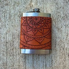 a flask with a flower design on it