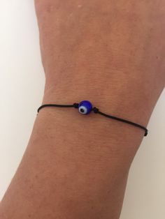 "BUY TWO GET A THIRD FOR FREE!! (please, don't add your free product to your shopping cart or you will be charged for it. Pick 1 product and leave the full name of it in the \"Note to enjoywelrydesign\" Box during checkout.)This is a black nylon cord bracelet with a crystal evil eye. Wear this bracelet to protect yourself. The evil eye is a curse believed to be cast by a malevolent glare, usually given to a person when they are unaware. Talismans created to protect against the evil eye. The brac Adjustable Evil Eye Bracelet With Sliding Knot, Trendy Adjustable Evil Eye Friendship Bracelets, Adjustable Spiritual Evil Eye Bracelet With Sliding Knot, Trendy Adjustable Evil Eye Bracelet For Gift, Casual Adjustable Evil Eye Bracelet As Gift, Casual Evil Eye Friendship Bracelets As Gift, Casual Evil Eye Friendship Bracelets For Gifts, Handmade Casual Evil Eye Bracelet, Casual Evil Eye Bracelets