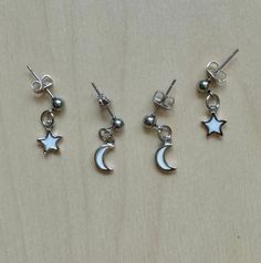 This is sold as a set. Earring set includes 1 pair of moon earrings and 1 pair of star earrings. White Celestial Star Earrings, Celestial White Star Earrings, Dainty White Earrings With Star Charm, White Star Charm Earrings As Gift, White Star-shaped Earrings With Star Charm, White Celestial Earrings With Moon Charm, White Star-shaped Nickel-free Earrings, White Moon-shaped Earrings For Pierced Ears, White Sterling Silver Earrings With Star Charm