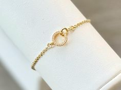 This beautiful CZ gold filled interlocking circle charm bracelet is adjustable and fits up to an 8" wrist. Bracelet slides to open and secure.  Layer it with any of our gold filled bracelets to create your own personalized stack.  Each bracelet is sold separately* 🤍 Made of: 14K Gold filled chain, hypoallergenic; (lead and nickel free); cubic zirconia; 14K Gold Plated Brass circle charm 🤍 15x8.5mm charm NOTE:  Color may vary slightly than picture due to different display devices and settings. Elegant Adjustable Circular Chain Bracelet, Adjustable Gold Dainty Heart Bracelet, Delicate Adjustable Round Charm Bracelet, Dainty Adjustable Gold Heart Bracelet, Dainty Gold Heart Bracelet Adjustable, Delicate Adjustable Gold Charm Bracelet, Adjustable Dainty Gold Bracelet For Anniversary, Adjustable Gold Bracelet For Anniversary, Delicate Adjustable Yellow Gold Charm Bracelet