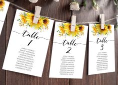 sunflower wedding seating cards hanging from clothes pins