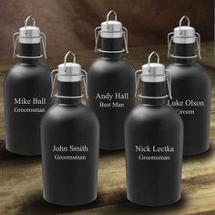 four black growl bottles with names on them