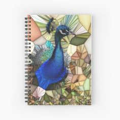 a blue peacock surrounded by colorful leaves and stones spiral notebook on top of a white surface