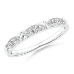 a white gold wedding ring with three diamonds on the sides and an intricate design in the middle