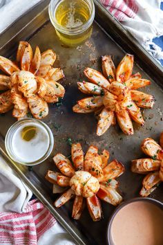 grilled shrimp on a tray with dipping sauce