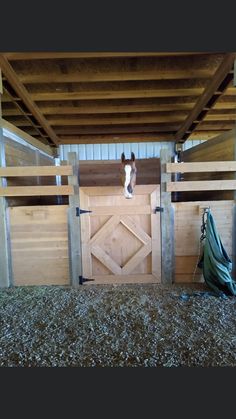 the inside of a horse barn with two stalls