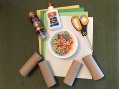 the supplies needed to make this craft include toilet paper rolls, scissors and cereal in a bowl