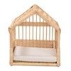 a wooden crib with white sheets on the bottom and bottom part, in front of a