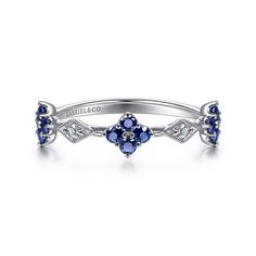 a white gold and blue sapphire flower ring