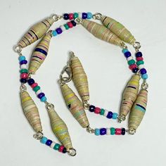 Add Some Vibrancy To Your Outfit With This Handmade Necklace From Fancy Knots. The Necklace Features Multiple Pastel Colors Of Paper Beads And Glass Beads, All Connected By Silver Links. This Beaded Masterpiece Is Perfect For Those Who Love To Experiment With Different Styles And Materials. The Necklace Is A Great Addition To Any Jewelry Collection And Can Be Worn On Any Occasion. With Its Unique Blend Of Colors And Materials, This Necklace Is Sure To Make A Statement. Get Your Hands On This One Fancy Knots, Knots Jewelry, Orange Statement Necklace, Paper Bead Necklace, Paper Bead Bracelet, Paper Beads Necklace, Artisan Jewelry Necklaces, Paper Bead Jewelry, Stone Choker