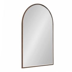 an arched mirror is shown against a white background and has beaded trim around the edges