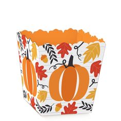 an orange and white fall themed paper cupcake box with pumpkins, leaves and acorns on it