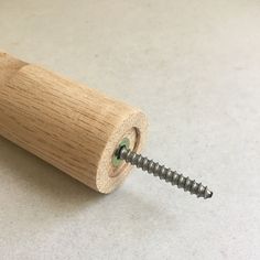 a screw is attached to the end of a piece of wood that has been turned upside down