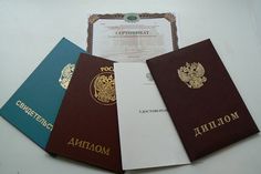 four different colored passports sitting next to each other on top of a white countertop