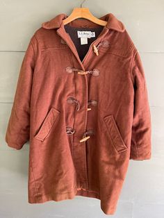 Ladies vintage brown wool toggle coat by LL Bean  fits medium to large.  arm pit= 24 length = 33 condition = needs cleaned. wrinkled with lint Brown Pea Coat For Winter, Brown Pea Coat For Cold Winter Weather, Brown Winter Pea Coat For Cold Weather, Brown Wool Coat For Fall Cold Weather, Brown Hooded Wool Coat For Winter, Brown Wool Coat For Cold Weather In Fall, Brown Long Pea Coat For Cold Weather, Vintage Brown Wool Outerwear, Vintage Brown Pea Coat For Winter