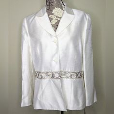 Le Suit White/Ivory Blazer Embellished Beaded Embroidery Trim Making A Belt Like Look Size 16 Woman's New With Tag Some Wrinkles From Storage Elegant White Embellished Blazer, Spring Wedding Embellished Blazer, White Embellished Outerwear For Wedding, Fitted White Embellished Outerwear, Elegant Embroidered Spring Blazer, White Embellished Long-sleeved Blazer, Elegant White Embroidered Outerwear, Embellished White Blazer, White Silk Blazer For Wedding