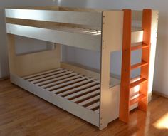 a wooden bunk bed sitting on top of a hard wood floor next to a wall