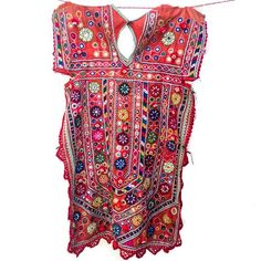 A traditional style of blouse (kanchli or choli) from the Banjara nomadic tribe of Rajasthan. Traditional Festive Kaftan With Mirror Work, Bohemian Traditional Wear With Mirror Work For Festive Season, Festive Bohemian Traditional Wear With Mirror Work, Red Bohemian Traditional Wear For Ceremonies, Traditional Multicolor Kaftan With Embroidered Border, Traditional Embroidered Kaftan For Festivals, Festival Chanderi Kaftan With Mirror Work, Chanderi Kaftan With Mirror Work For Festivals, Traditional Red Kaftan For Festival