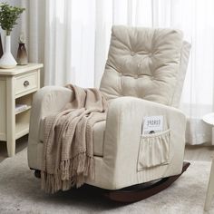 a rocking chair with a blanket on top of it