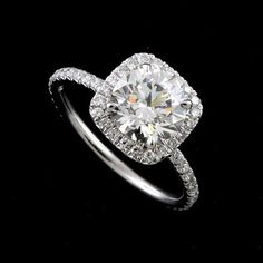 a diamond engagement ring on a black background