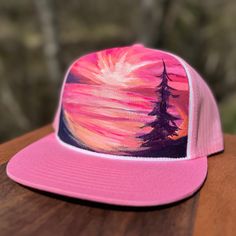 Looking for a way to stand out from the crowd? Check out Mary Bea Art's unique hand-painted hats! Each hat is a one-of-a-kind piece of wearable art, individually painted by Petoskey artist Mary Bea McWatters. With their bold colors and eye-catching designs, these hats are the perfect way to express your individual style and show off your love of nature and art. Whether you're looking for a way to add a pop of color to your outfit or just want a unique accessory that's sure to turn heads, Mary Bea Art's hand-painted hats are the perfect choice. Don't settle for ordinary - choose something truly special with a hand-painted hat! Artistic Hand Painted Flat Brim Hat, Pink Trucker Hat With Curved Brim For Festivals, Artistic Hand Painted Adjustable Hats, Hand Painted Snapback Hat, Hand Painted Adjustable Snapback Hat, Adjustable Pink Flat Bill Hat, Adjustable Pink 5-panel Hat, Pink Adjustable 5-panel Hat, Artistic Hand Painted Cap