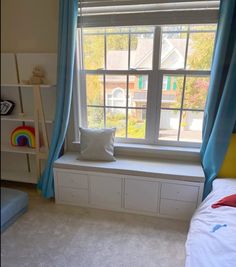 a bed room with a neatly made bed next to a window and bookshelf