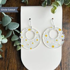 Step back in time and embrace the vintage vibe with our Daisy Patterned Earrings. These stunning earrings are made from high-quality clear acrylic and feature a fun and playful daisy pattern, reminiscent of the carefree era of the 70s. The intricate detailing and bold colors of the design make these earrings a showstopper, sure to add a touch of retro-chic to any outfit. Crafted with comfort in mind, these earrings are incredibly lightweight, making them ideal for everyday wear. The clear acryli Vintage Summer Hoop Earrings, Vintage Dangle Earrings For Spring, Summer Vintage Pierced Earrings, Vintage Round Earrings For Summer, Vintage White Flower Drop Earrings, Retro Flower-shaped Earrings For Gift, Vintage Drop Earrings With Flower Charm, Retro White Dangle Earrings, Handmade Vintage Hoop Earrings For Summer