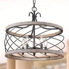 a chandelier with three lights hanging from it's center circle and an iron frame