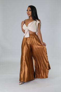 These high-waisted pants are for the fashion-forward woman who wants to make an elegant statement wherever she goes. Featuring a comfortable elastic waistband and pleated detail, these wide-legged beauties will take your wardrobe to the next level. Show off your chic style in these luxurious high-waisted pants. High waisted pants Elastic waistband Pleated Wide leg 30"Inseam No closure 97% Polyester 3% Spandex Hand wash cold Contemporary Costumes, Balloon Pants, Pants High Waisted, Grey Pants, High Waisted Pants, Style Me Pretty, Next Level, Casual Chic, Chic Style