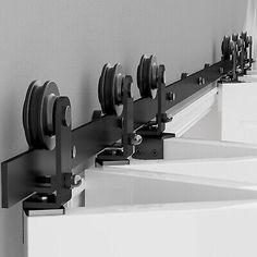 a row of black and white wall mounted mirrors